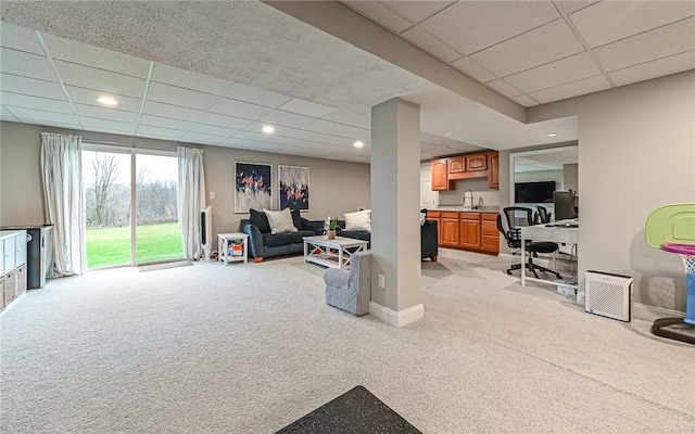 interior space featuring a drop ceiling and sink