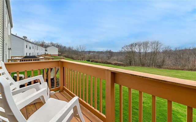 wooden terrace with a lawn