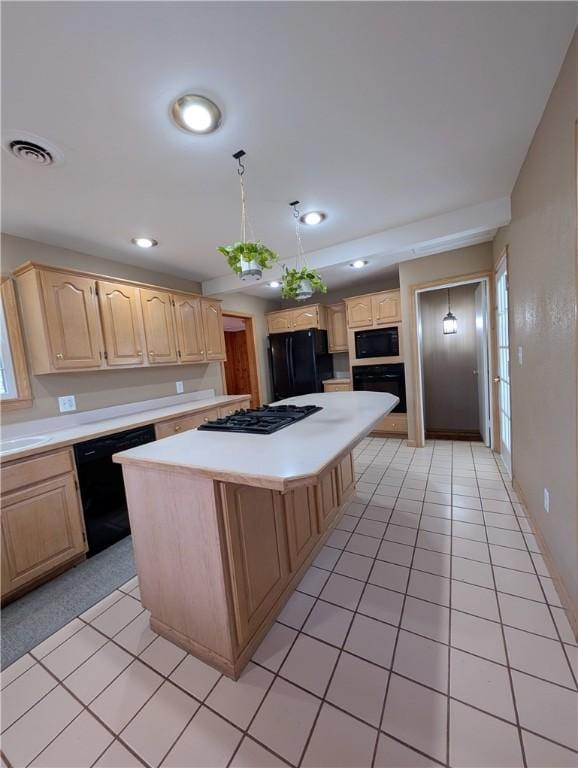 kitchen with light tile patterned flooring, light brown cabinets, a center island, and black appliances