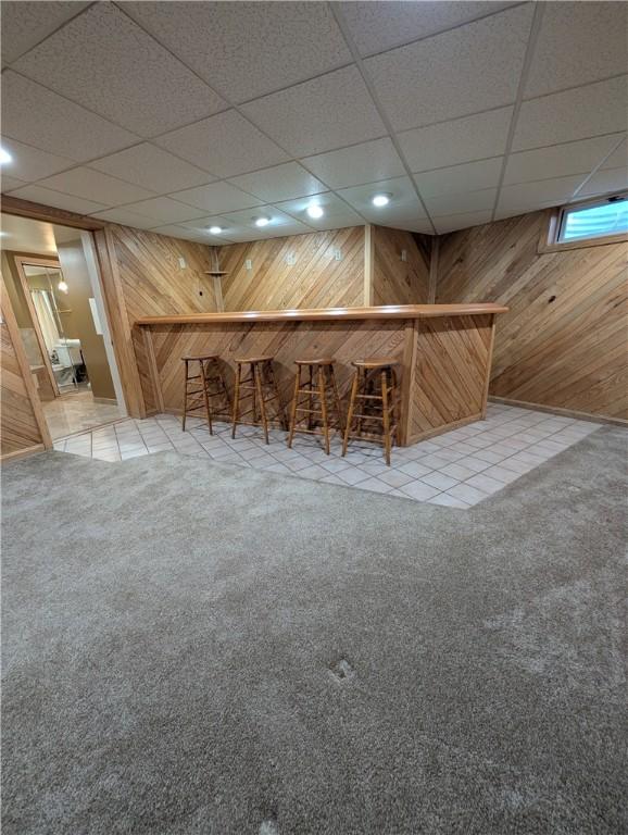 bar with wood walls and carpet floors