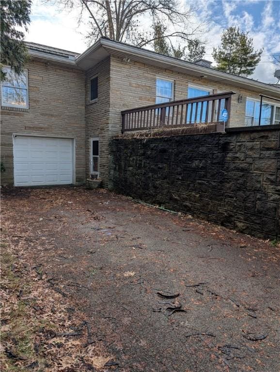 back of property featuring a garage