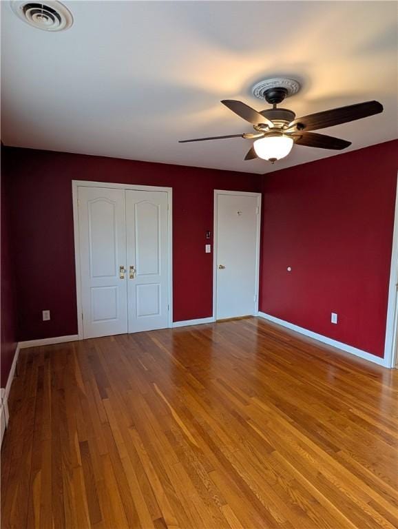 unfurnished bedroom featuring ceiling fan and light hardwood / wood-style floors