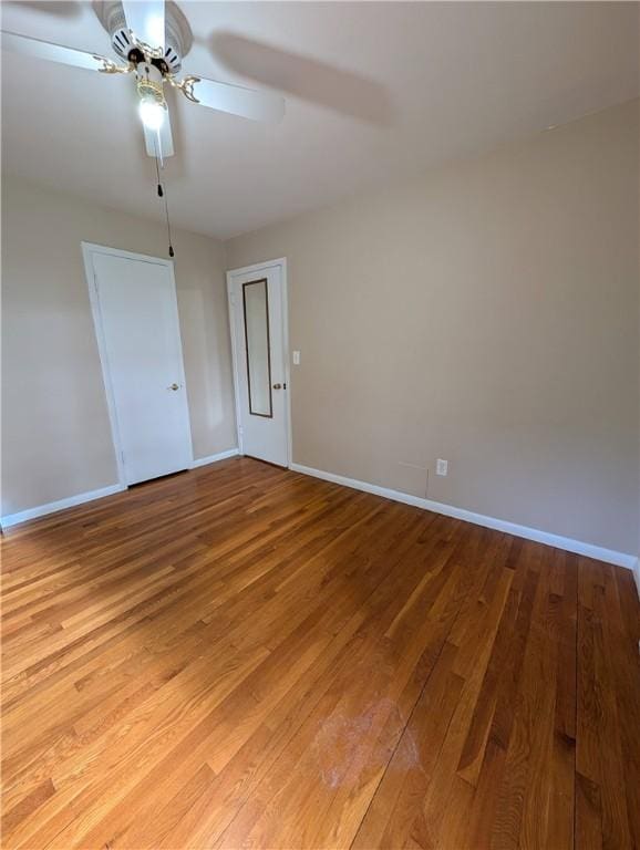 empty room featuring ceiling fan and light hardwood / wood-style flooring