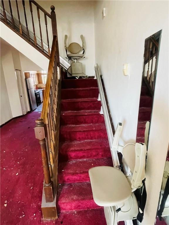 staircase featuring carpet