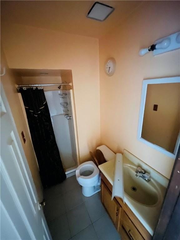 bathroom with tile patterned floors, vanity, curtained shower, and toilet