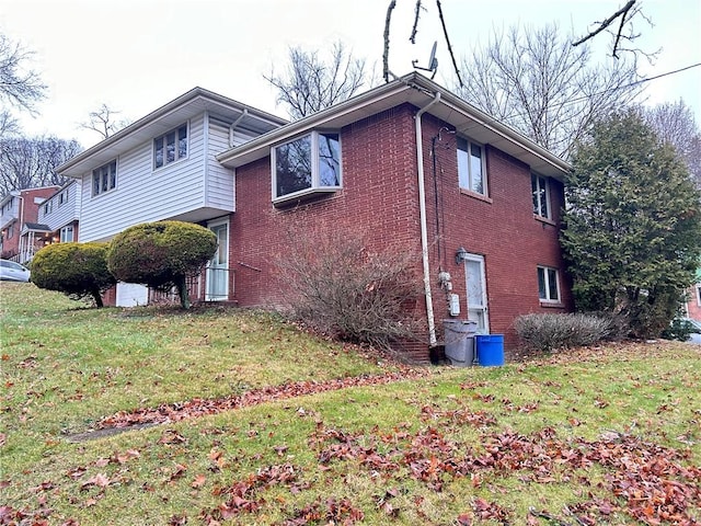 view of side of home featuring a yard