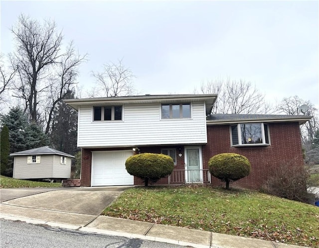 tri-level home featuring a garage and a front yard