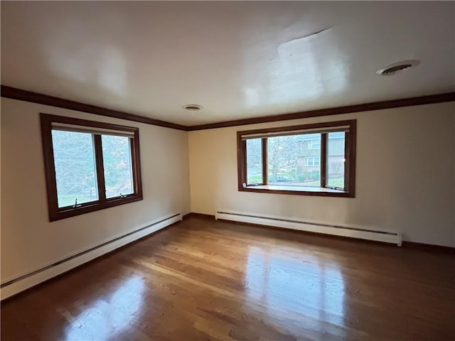 unfurnished room with hardwood / wood-style flooring, ornamental molding, and baseboard heating