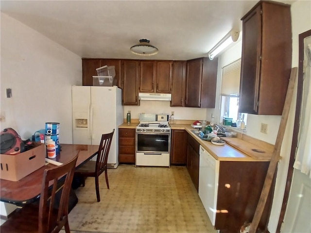 kitchen featuring white appliances and sink