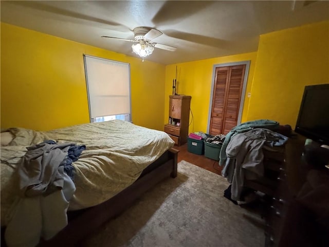 bedroom with ceiling fan and a closet