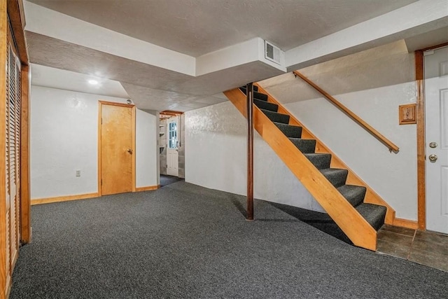 basement with dark colored carpet