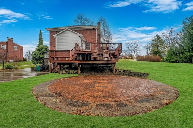 back of house featuring a lawn, a patio area, and a wooden deck