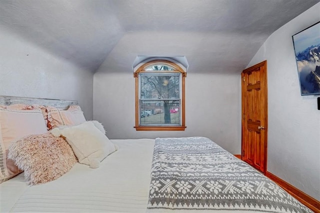 bedroom featuring lofted ceiling