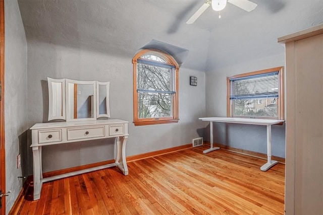 interior space featuring ceiling fan, vaulted ceiling, and light hardwood / wood-style flooring