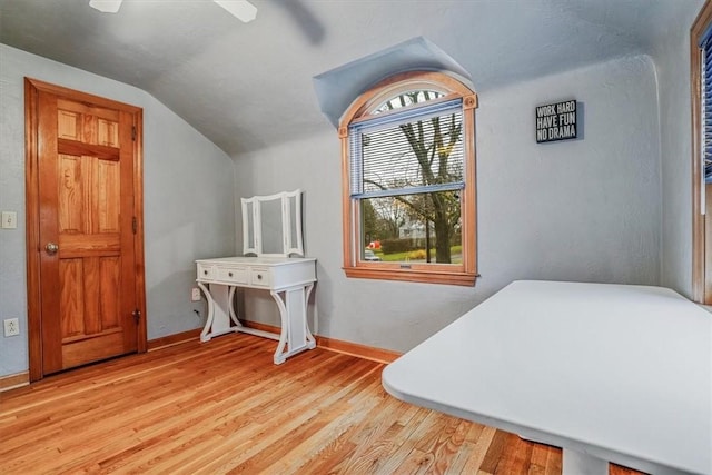 bedroom with ceiling fan, lofted ceiling, and light hardwood / wood-style flooring