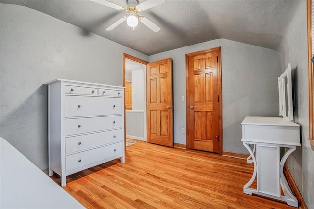 bedroom featuring ceiling fan, lofted ceiling, and light hardwood / wood-style flooring