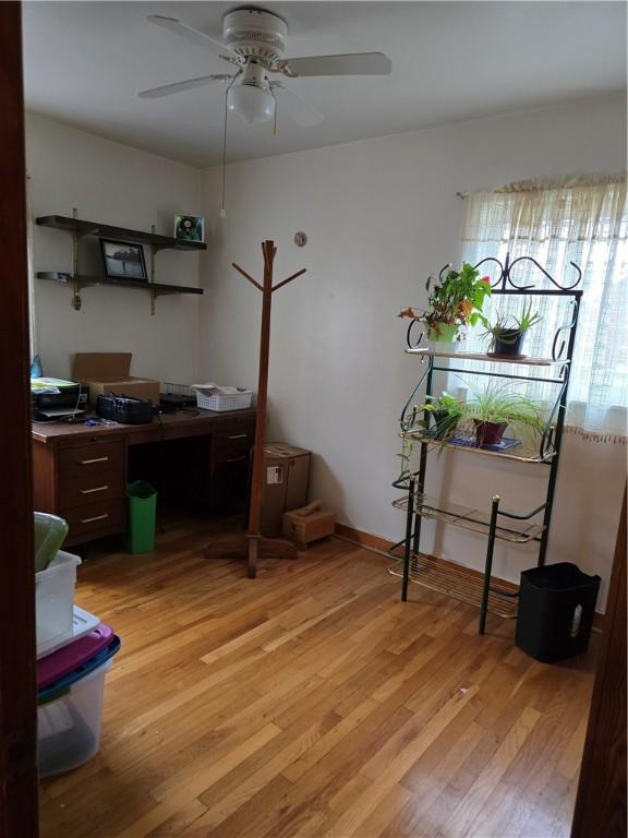 office area with light wood-type flooring and ceiling fan