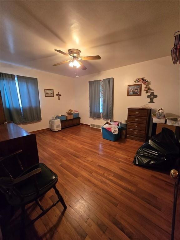 misc room with wood-type flooring and ceiling fan