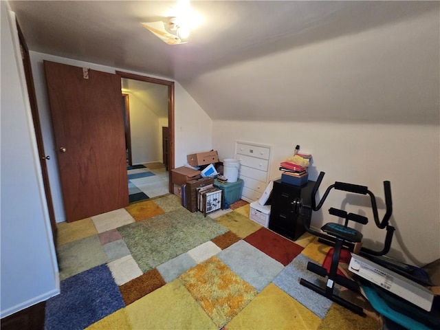 exercise room with vaulted ceiling