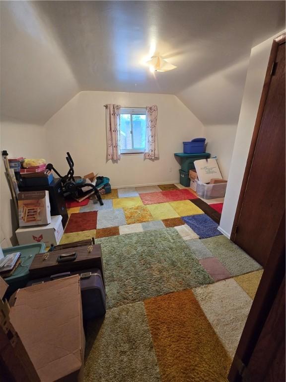 interior space with carpet flooring and lofted ceiling