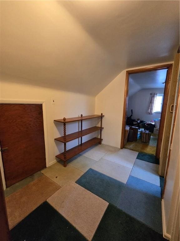 additional living space featuring lofted ceiling