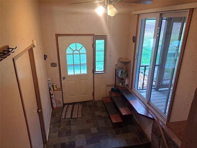 doorway to outside featuring ceiling fan