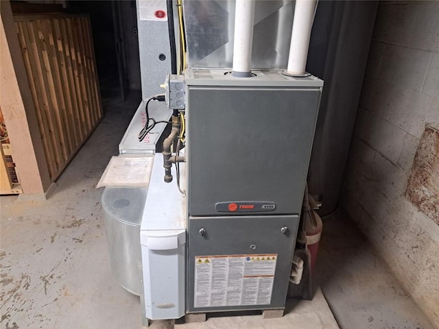 utility room featuring heating unit