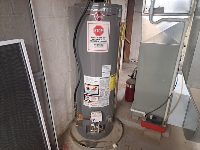 utility room featuring heating unit and water heater