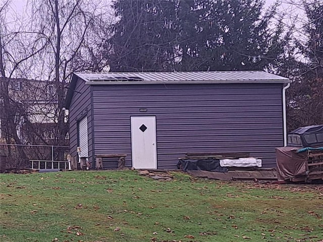 view of outbuilding with a lawn