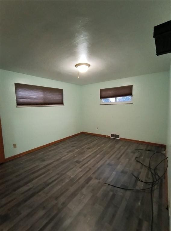 additional living space with dark wood-type flooring