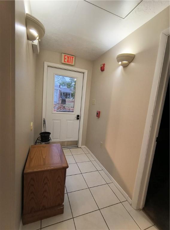 entryway with light tile patterned flooring