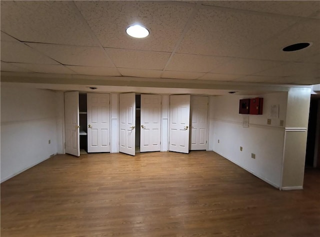 unfurnished bedroom featuring hardwood / wood-style floors and a paneled ceiling