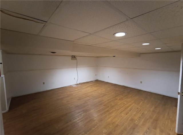 unfurnished room featuring hardwood / wood-style flooring and a drop ceiling