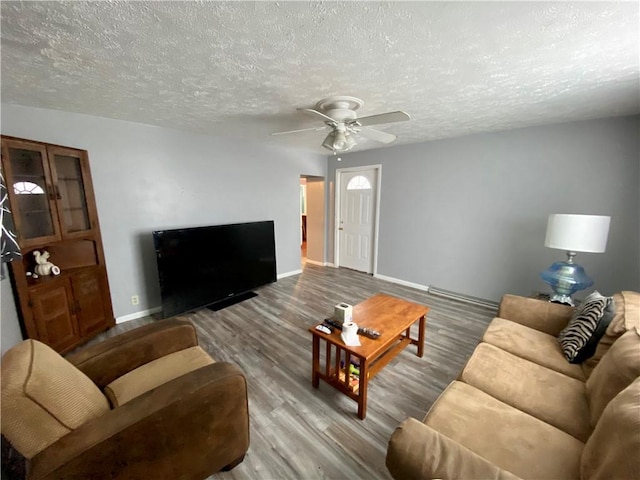 living room featuring hardwood / wood-style floors, a textured ceiling, and ceiling fan