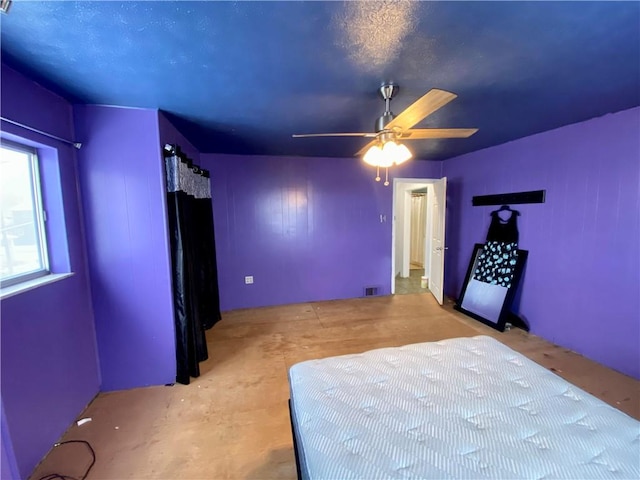 unfurnished bedroom with a textured ceiling and ceiling fan