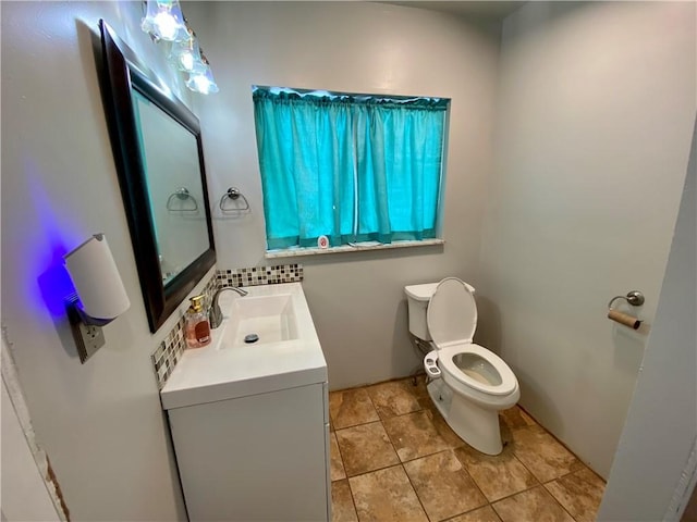 bathroom featuring tile patterned floors, vanity, and toilet