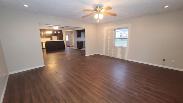 unfurnished living room featuring dark hardwood / wood-style floors and ceiling fan