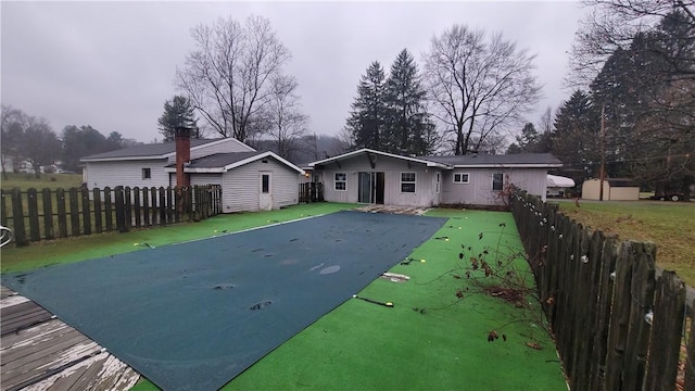 back of property featuring a covered pool