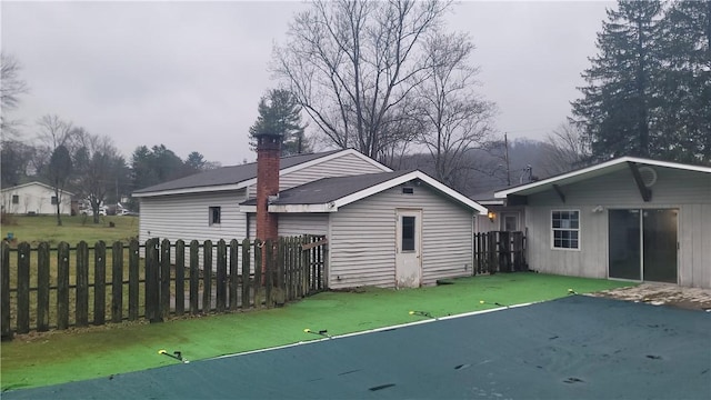 rear view of property featuring a yard