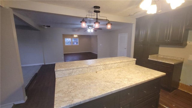 kitchen featuring dark hardwood / wood-style flooring, decorative light fixtures, and ceiling fan