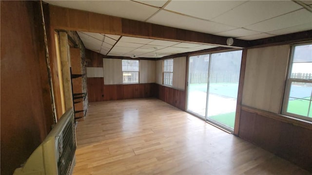 unfurnished sunroom featuring a drop ceiling