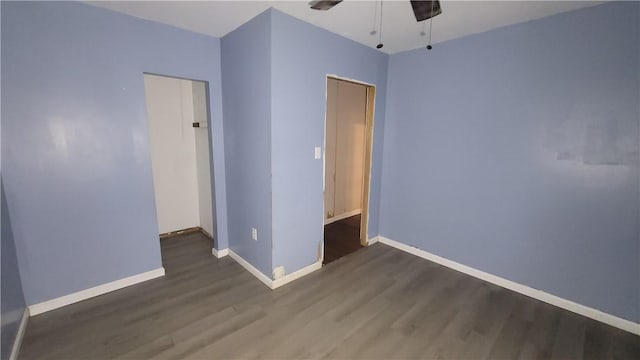 unfurnished bedroom featuring ceiling fan and dark hardwood / wood-style floors