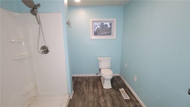 bathroom featuring a shower, hardwood / wood-style flooring, and toilet