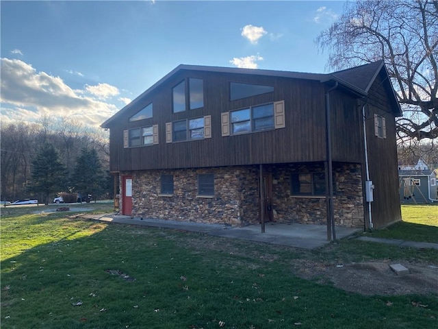 rear view of house featuring a patio area and a yard