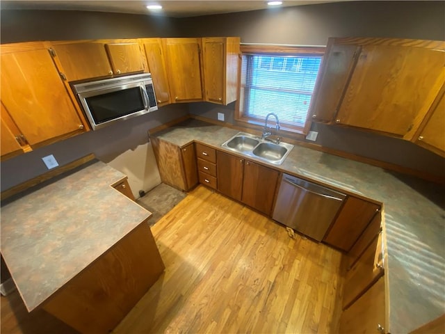 kitchen with sink, light hardwood / wood-style floors, and appliances with stainless steel finishes