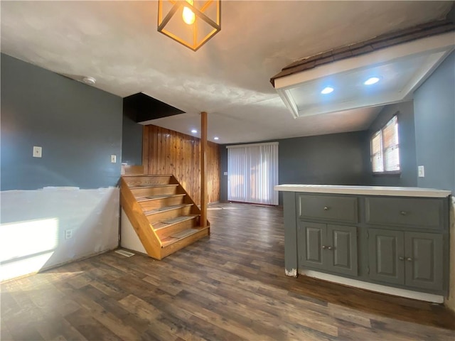 basement featuring dark hardwood / wood-style flooring and wooden walls