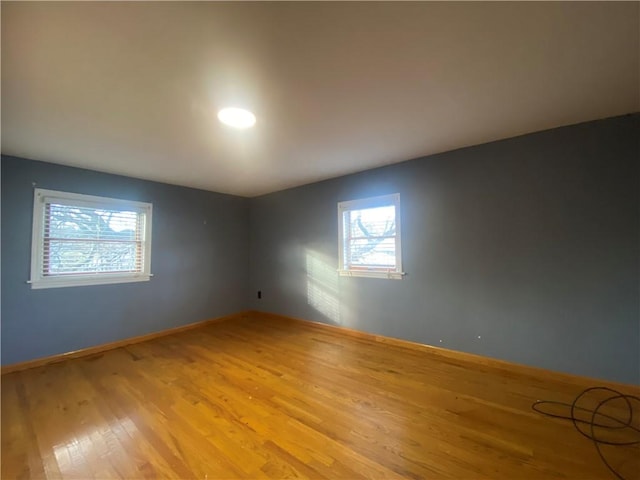 empty room with light hardwood / wood-style floors