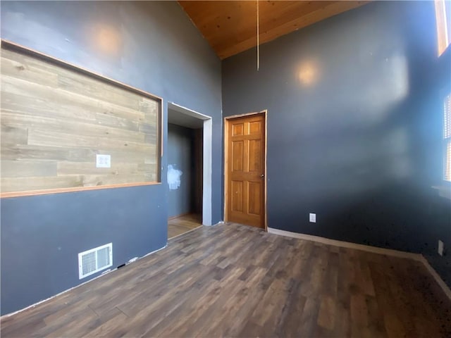 spare room with wood ceiling, wood-type flooring, and high vaulted ceiling