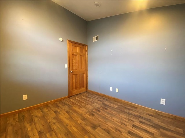 spare room with wood-type flooring