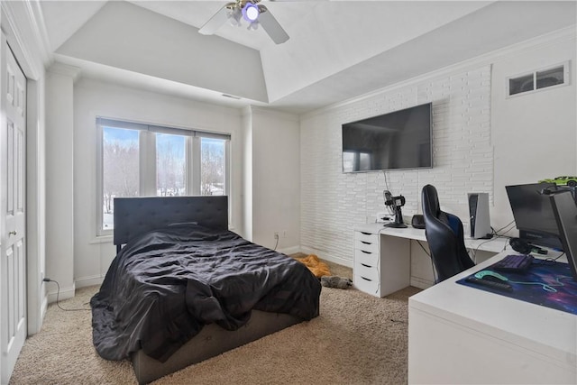 bedroom featuring light carpet, crown molding, ceiling fan, a tray ceiling, and a closet